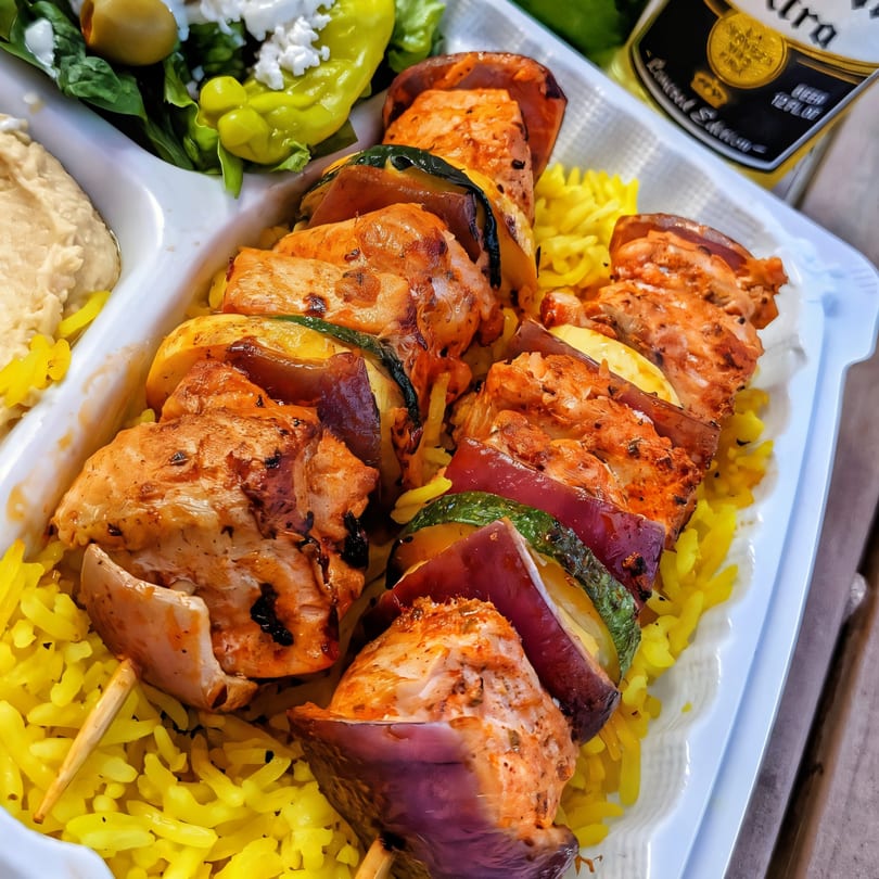 Chicken and vegetable skewers over yellow rice, with hummus and a side salad, from The Green Olive.